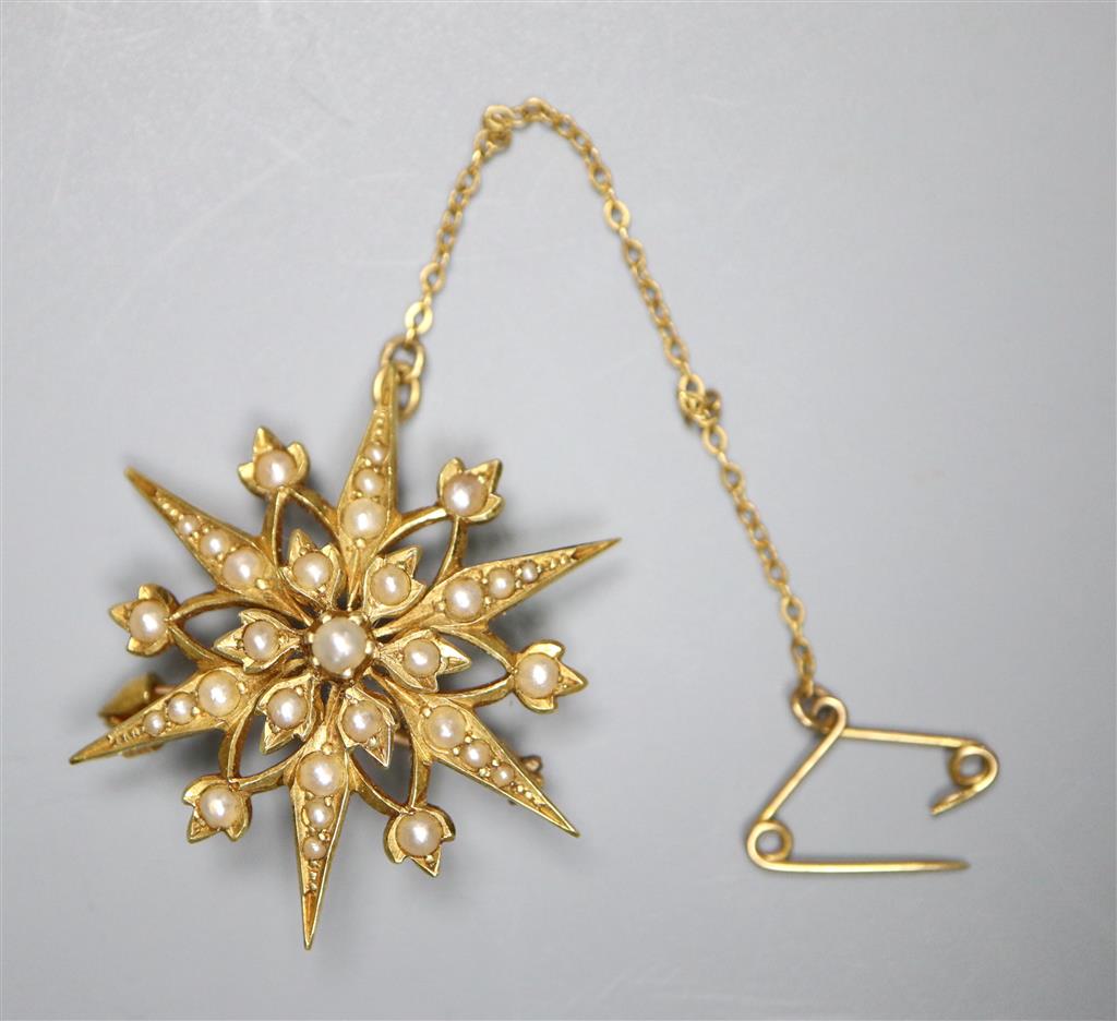 An Edwardian 15ct and graduated split pearl set starburst brooch, 31mm,